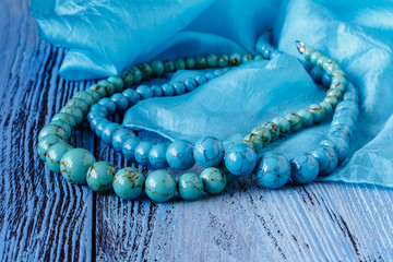 turquoise necklace on blue wooden table