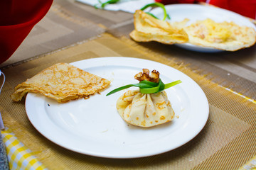 children stuff and decorate pancakes with jam and powder their own hands
