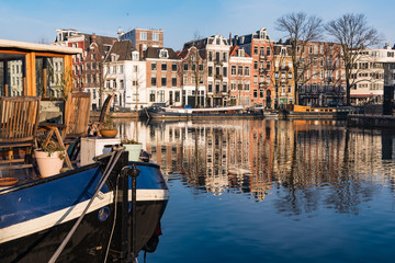 Fototapeta na wymiar Hausboot, Krachten, Häuser und Spiegelungen in Amsterdam