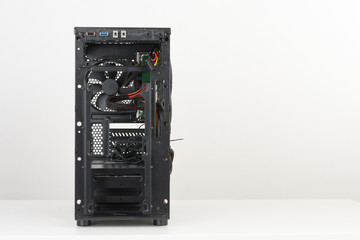 Building of PC, ATX motherboard inserted to black computer midi tower case.