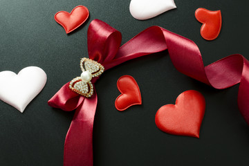 Fototapeta premium bow, ribbon with hearts on a black background