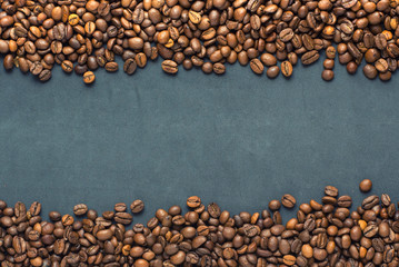 Closeup of coffee beans on grey background. Copy space