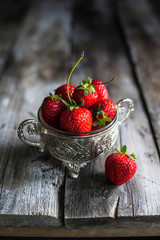 Ripe red strawberries on wooden table