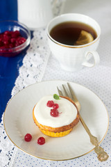 Mini cheesecake with whipped cream and red currant. Rustic style.