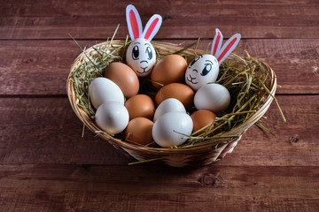 Basket with different eggs for Easter with an egg rabbit