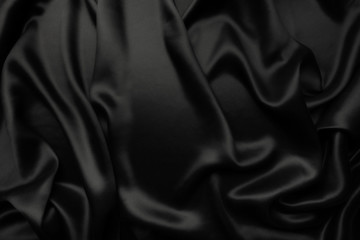 Fototapeta premium Elegant black satin silk with waves, abstract background