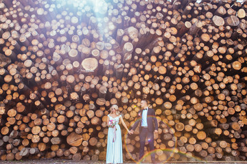 Bride and groom look happy standing before the blocks in the rays of sun