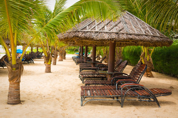 The leaves of brown thatched umbrellas in asian style on the beach
