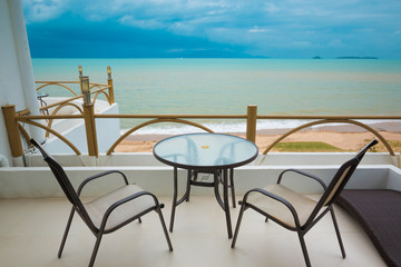 View from balcony on Blue ocean and sand beach under cloudy sky in a bad weather