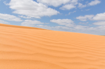 untouched yellow sand dunes and blue sky in the desert between Kalmykia and Astrakhan region