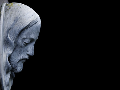 An ancient statue of Jesus Christ in profile (religion, faith, death, suffering, immortality, God concept)