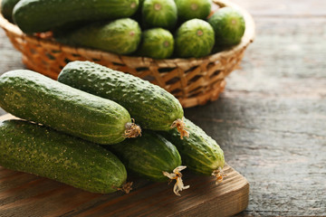 Fresh cucumbers on grey wooden table