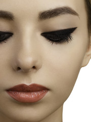 Naklejka premium Beautiful face of model of the woman with bright cosmetics of a charm. Pure skin, black eye shadow and eyeliner, red full lips. Photo of fashion, cosmetology, injections, lenses