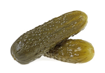 Two marinated pickled cucumbers on a white background