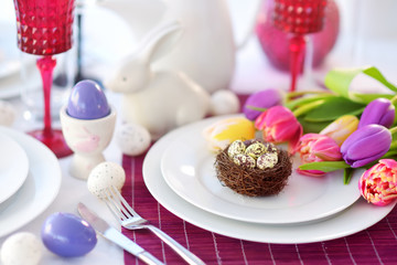 Beautiful table setting with crockery and flowers for Easter celebration