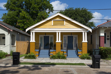 The facade of a traditional colorful house in the Marigny neighborhood in the city of New Orleans,...