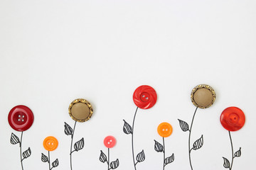 flowers from buttons on a white background. view from above. children's background - obrazy, fototapety, plakaty