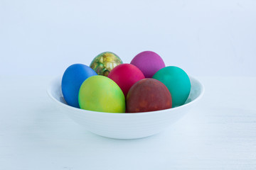 White Easter plate of multicolored boiled eggs decoration