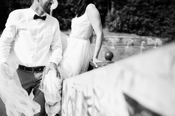 The lovely couple in love standing on the bridge