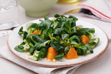 Fresh Korn salad with pine nuts and tangerine. Useful breakfast
