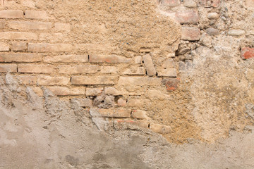 Old brown and ocher brick wall destroyed useful background or texture