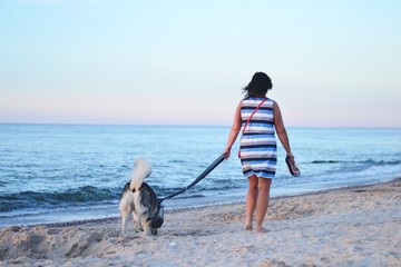 walking with a dog at the beach