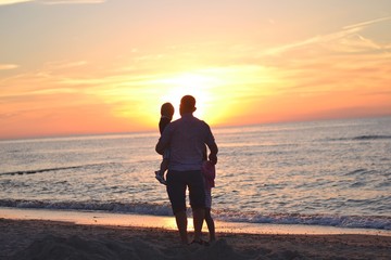 dad with children at the beach