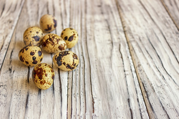 Quail eggs on a wooden table, a symbol of the Easter season. Healthy eating.
