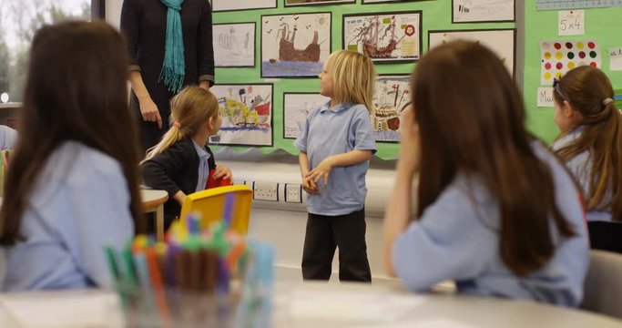 4k, Cute littel boy showing how to dab to his class teacher in a classroom. Slow motion.
