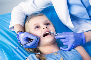 Little girl sitting in the dentists office