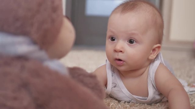 Cute little four month old baby boy, playing at home