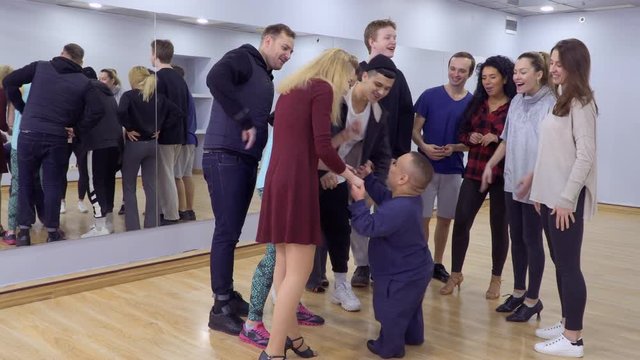 A group of people greetings their little friend in the studio