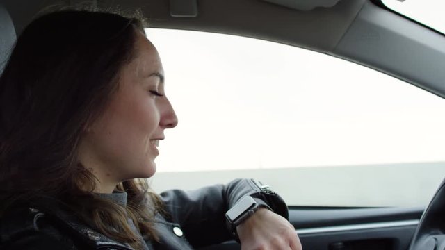Young Woman Uses Talks To Her Smartwatch While She Drives On The Freeway - Shot On Red Scarlet-W Dragon In 4K/Slow Motion