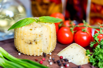 Rustic cheese with herbs, pepper and vegetables