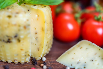 Rustic cheese with herbs, pepper and vegetables