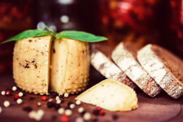 Rustic cheese with herbs, rye bread and peppercorn