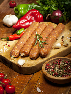 Raw sausages on wooden background