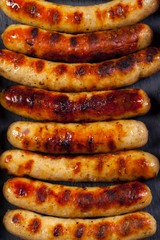 Wiener Sausages on black background. Top view.