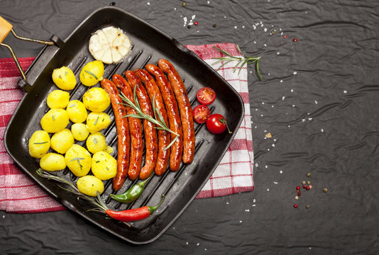 Wiener Sausages in a pan on black background