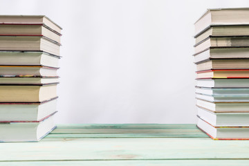 Pile of various books on bright wooden background. With copy space for your text