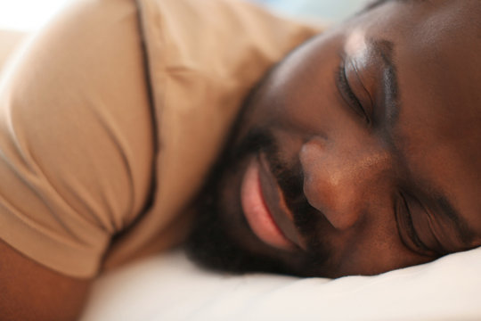 African American man sleeping in bed
