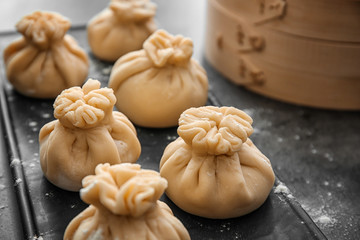 Plate with tasty baozi dumplings on table