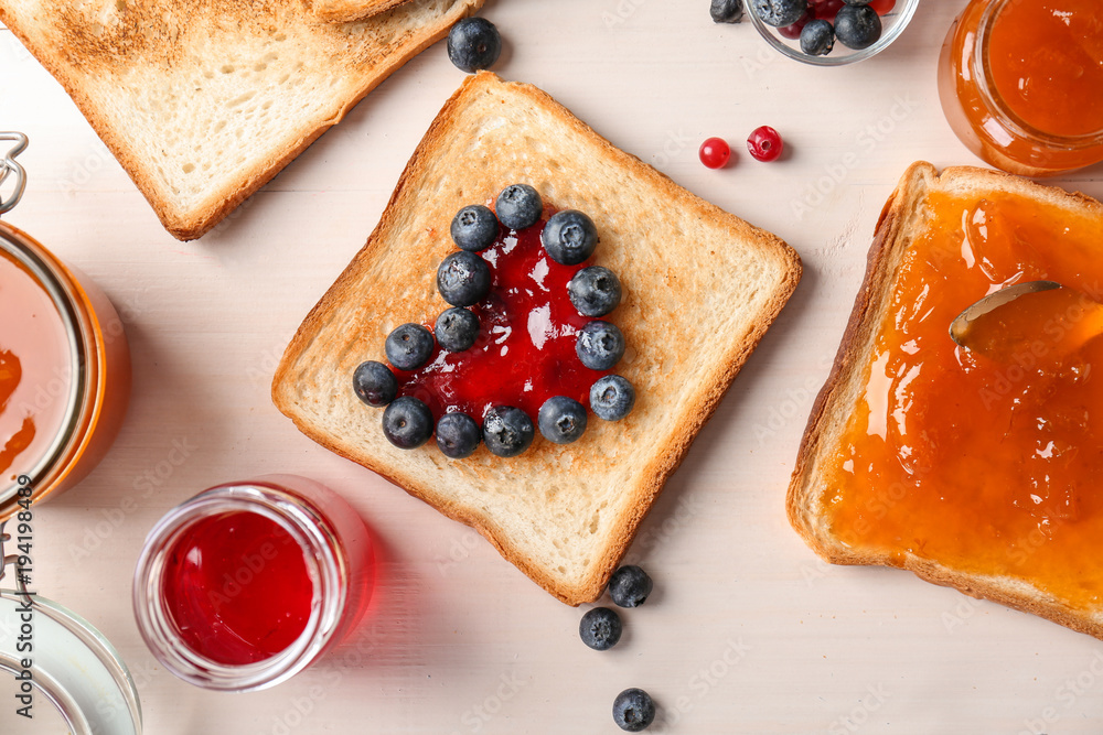 Sticker composition with sweet jams and toasts on wooden background