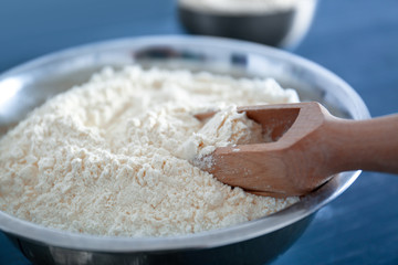 Bowl with flour and scoop, closeup