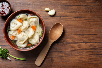 Bowl of delicious soup with dumplings on table