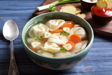 Bowl of delicious soup with dumplings on table