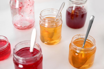 Jars with sweet jams on table