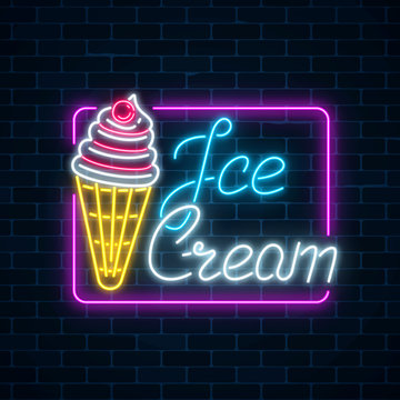 Glowing neon sign of ice cream with cherry on dark brick wall background. Fruit ice-cream in waffle cone.