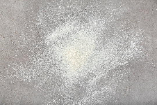 Scattered flour on grey background