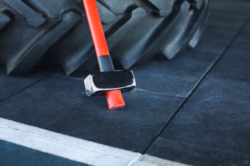 Heavy tire and hammer for training in gym